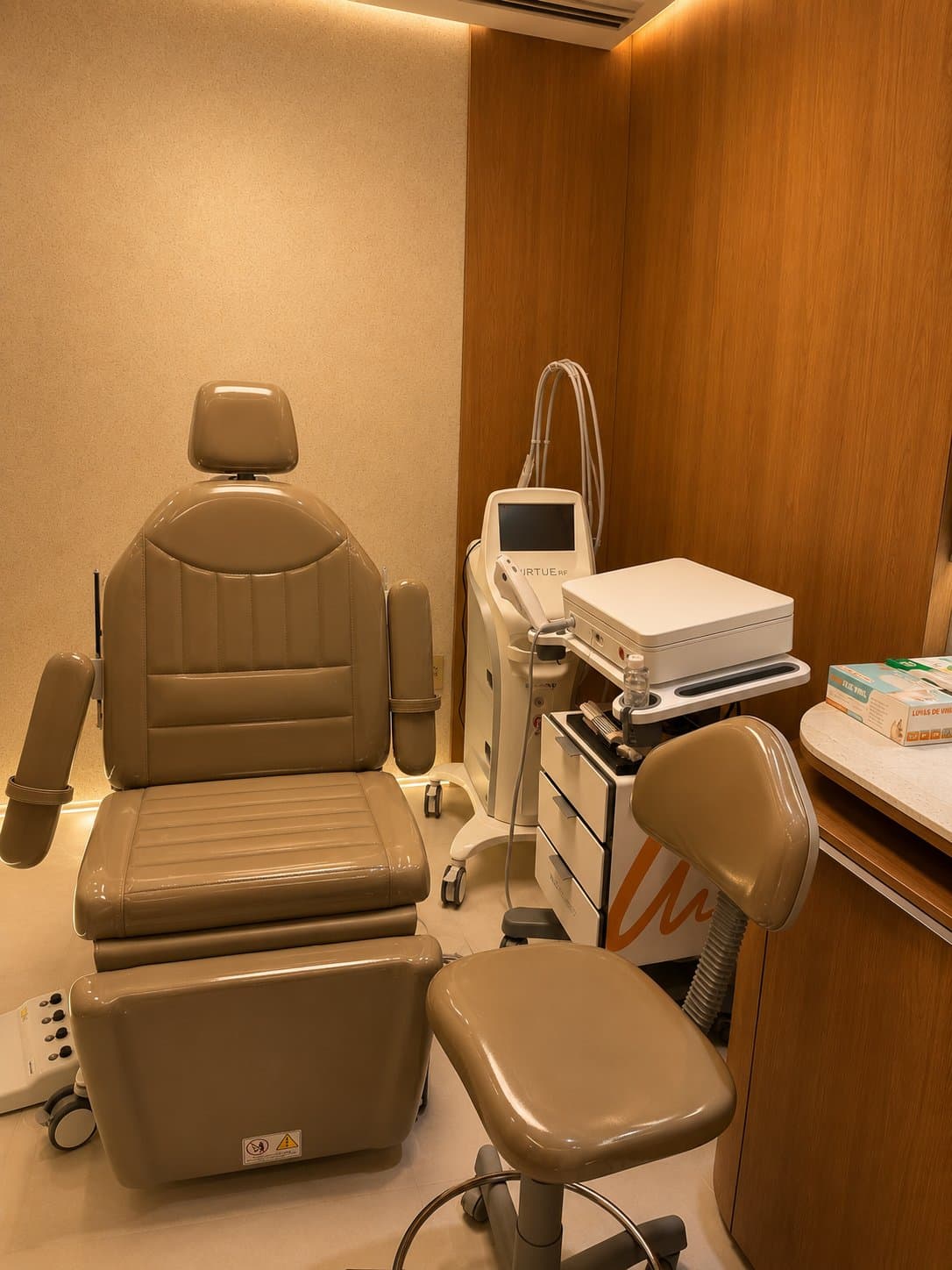 Sala de procedimentos Brasília: cadeira de atendimento e equipamentos de tecnologia médica entre madeira e luz indireta
